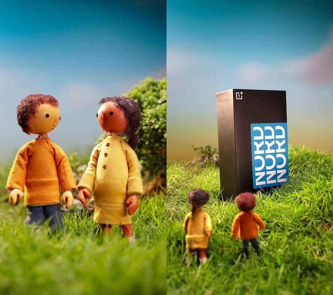 Two felt figures beside the phone box on a grassy hill